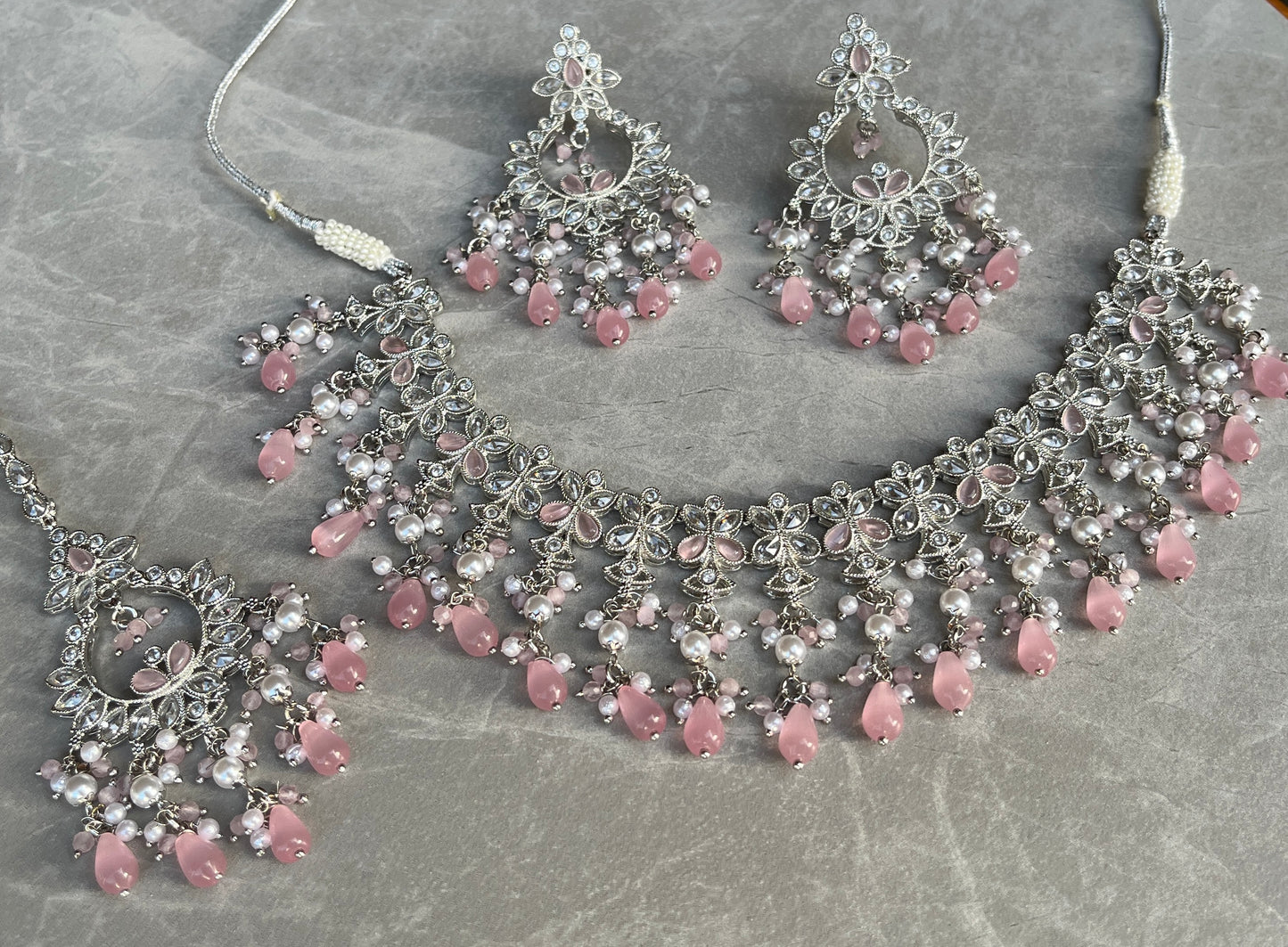 Silver Choker, Earring and Tikka set with White and Pink Coloured Stones. High-quality and perfect for indian weddings, bridal showers, functions, events, festivals and to give as gifts.